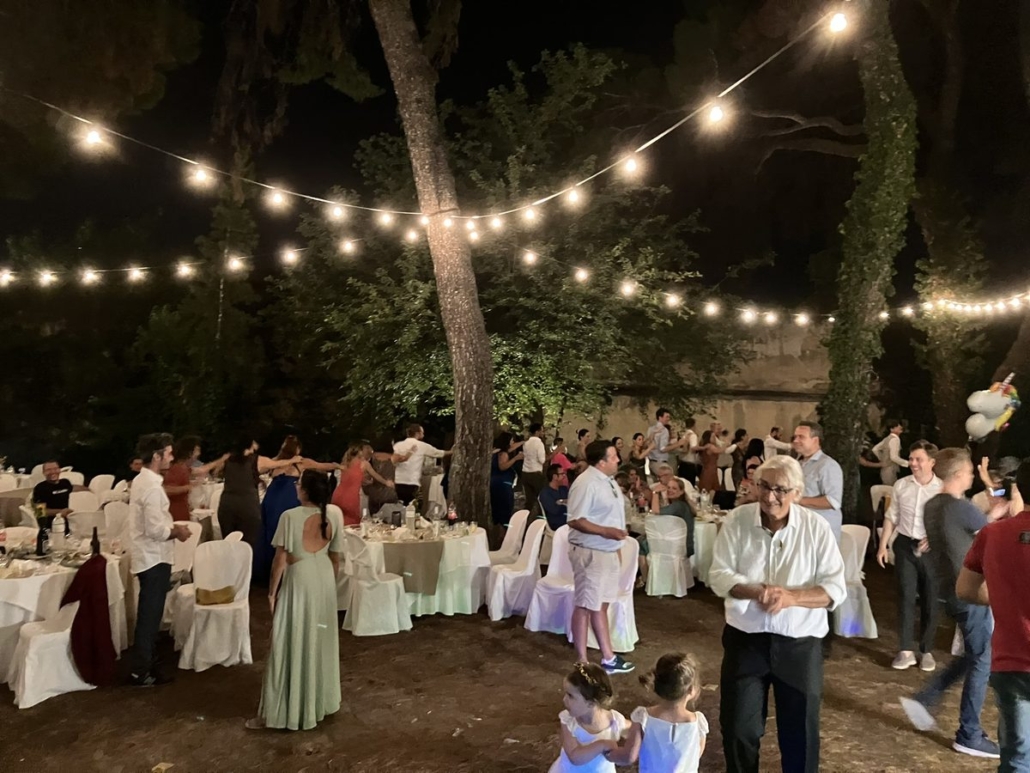 Wedding party under string lights and pine trees - Thessaloniki DJ Seitan