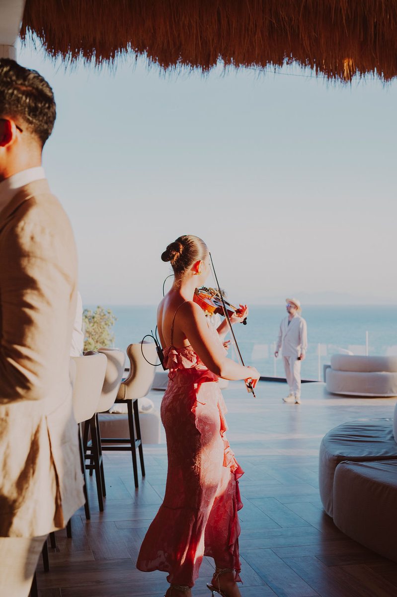 Cocktail hour with live violin and DJ Seitan at Mykonos destination wedding, Royal Myconian