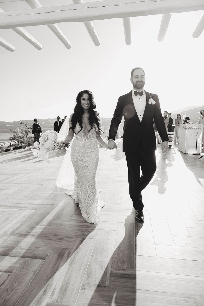 Mykonos destination wedding DJ – bride and groom exit at Royal Myconian, Elia