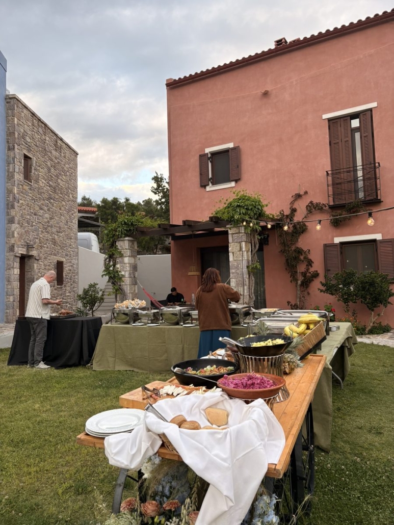 Outdoor wedding buffet spread at Chara Houses, Skoutari – Greek food stations with stone building backdrop