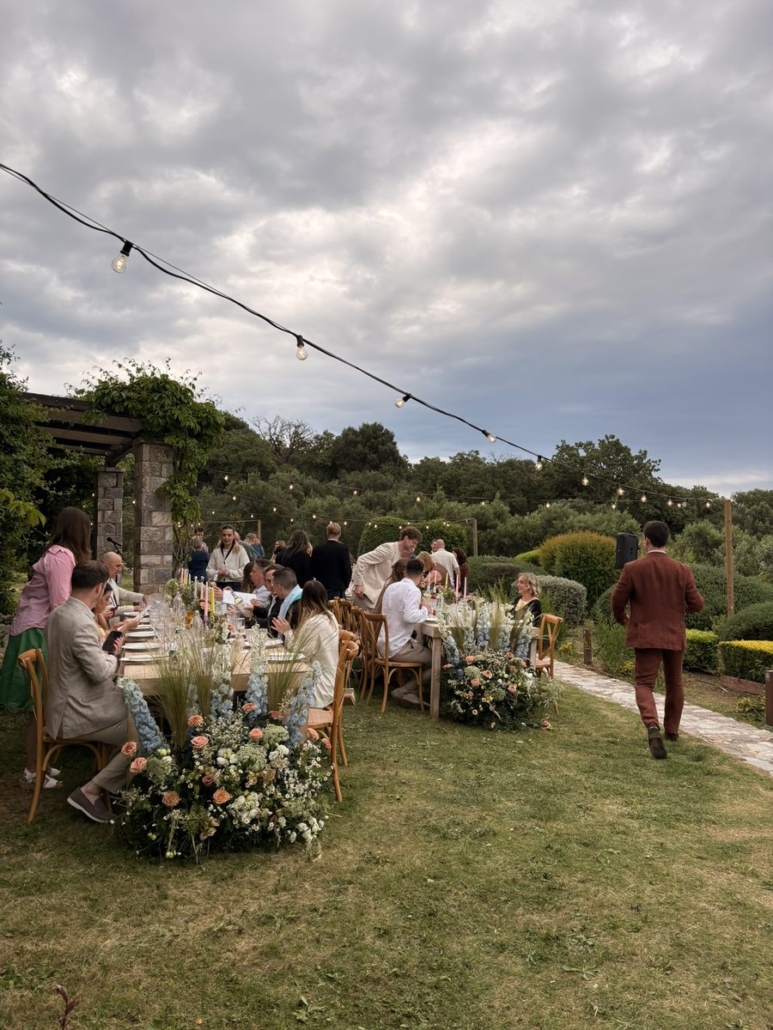 Wedding dinner reception at Chara Houses, Mani – guests seated at long tables under string lights